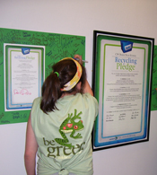 A Baker High School student signs her school's recycling pledge.