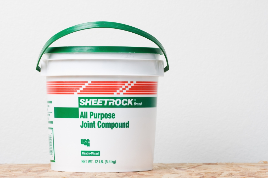 bucket of joint compound for sheetrock drywall
