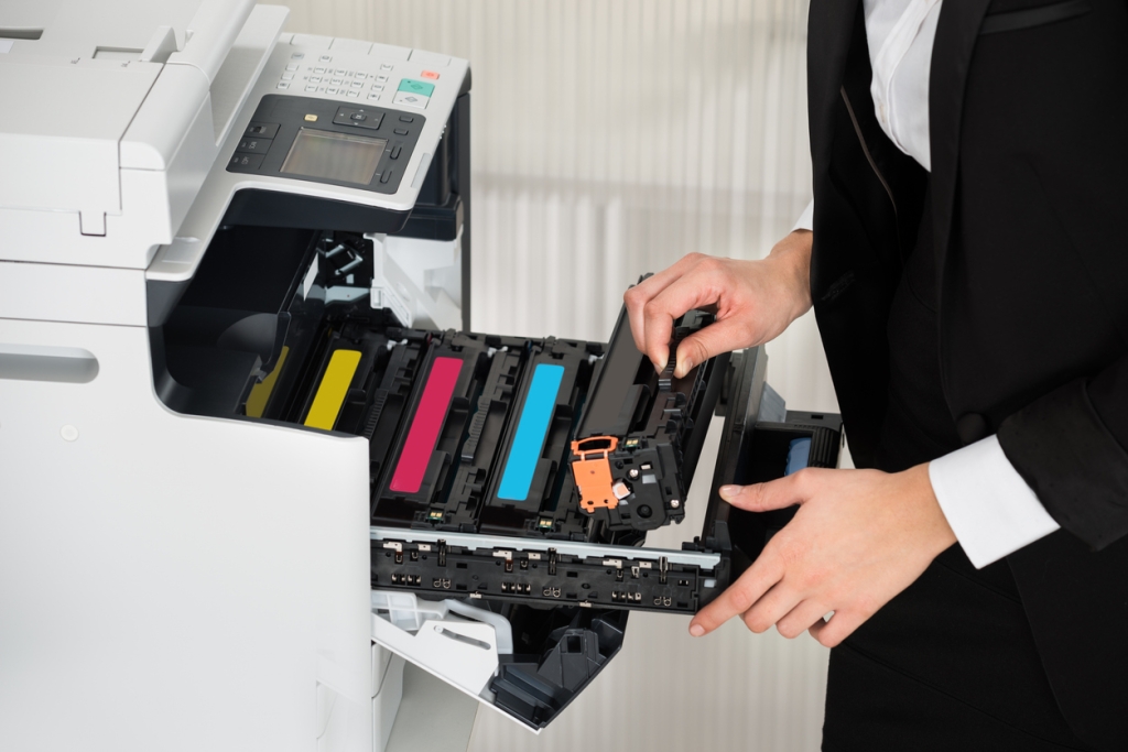 businessman fixing cartridge in printer machine at office