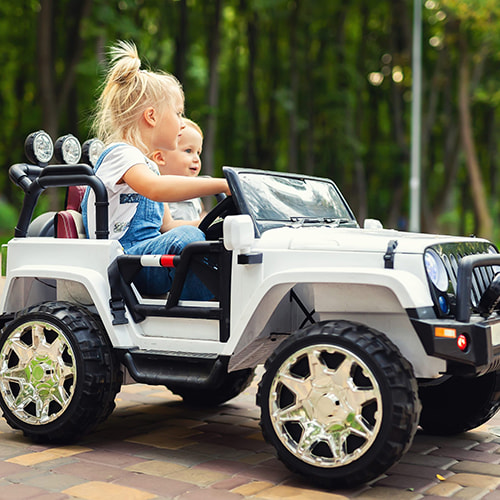 kids driving a power wheel