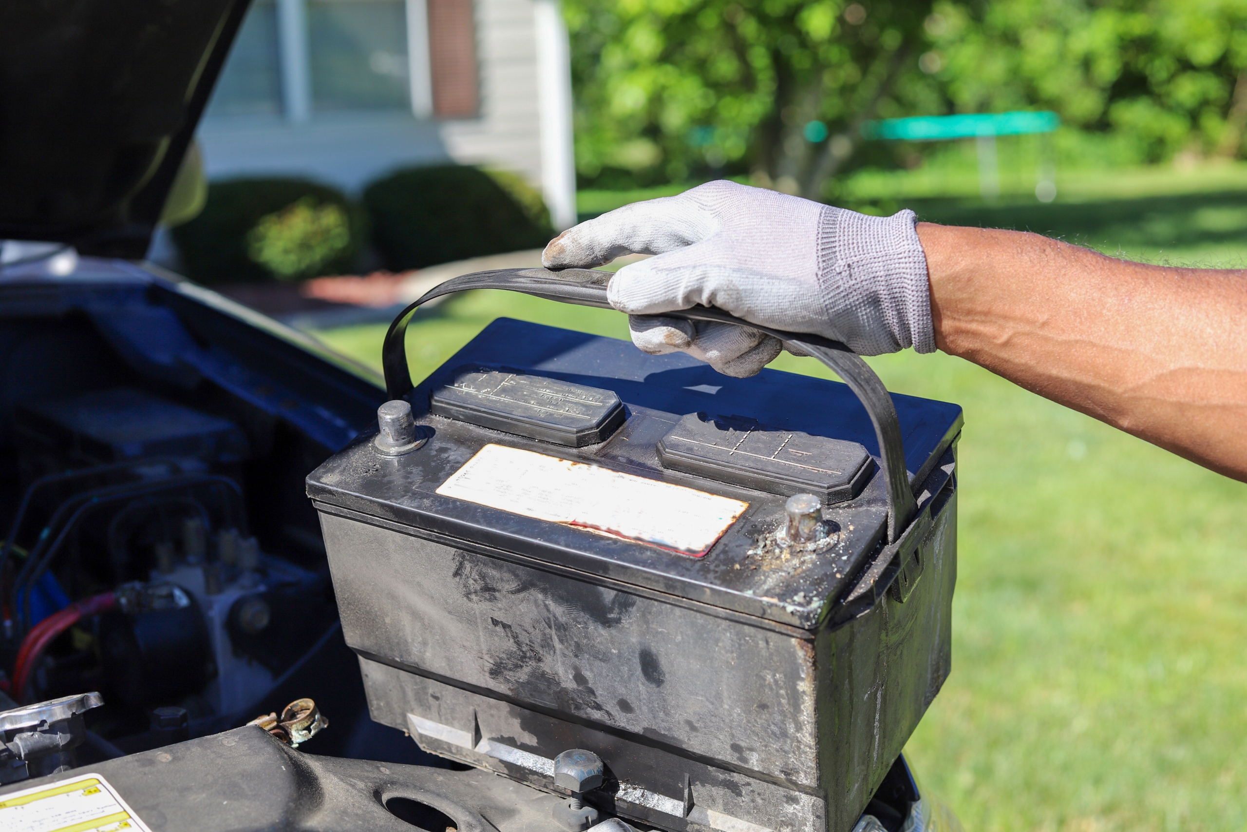 person replacing car battery