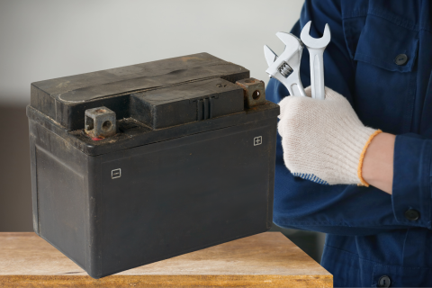 mechanic next to an auto battery