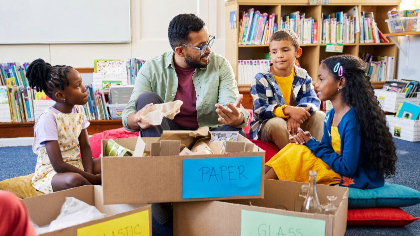 group of kids learning how to recycle