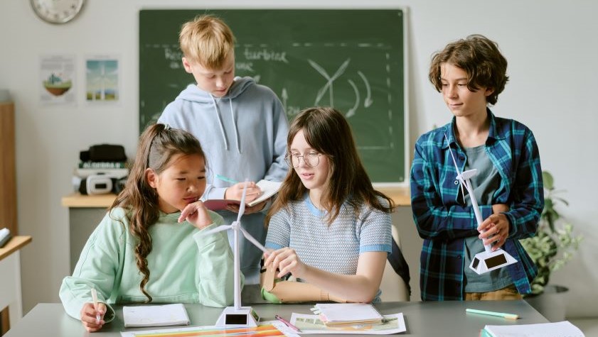 Group of multiethnic teenagers collaborating on science project,